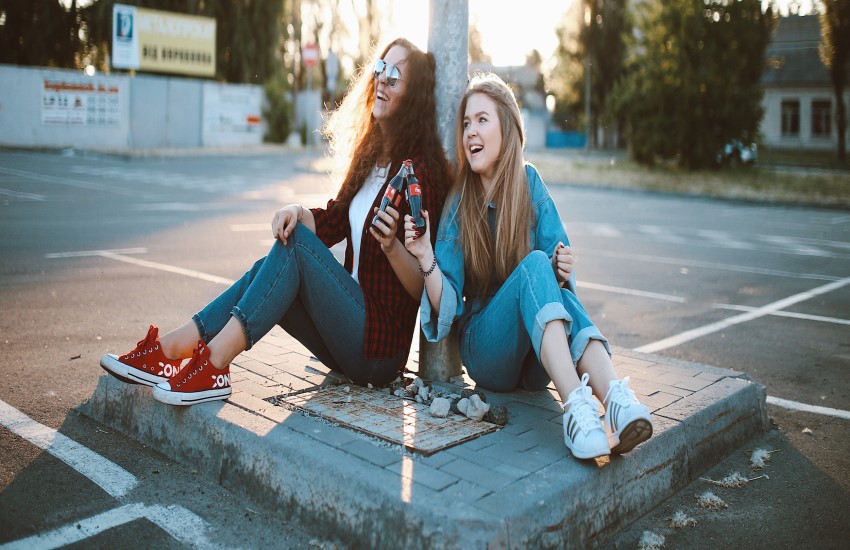 teens sitting on street
