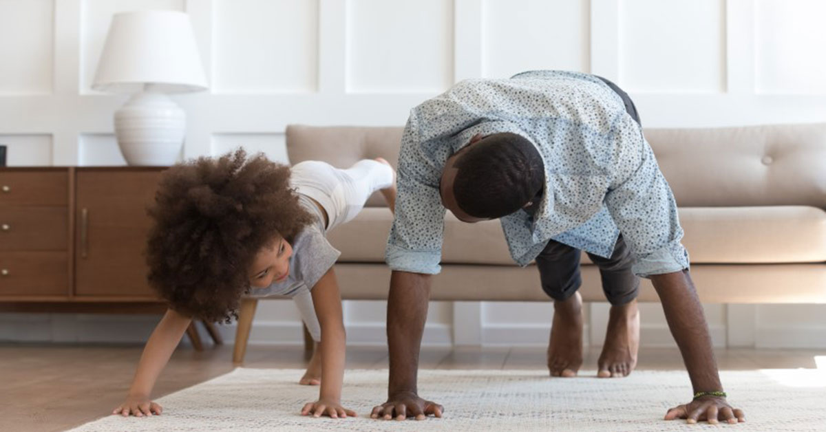 father and daughter doing push ups